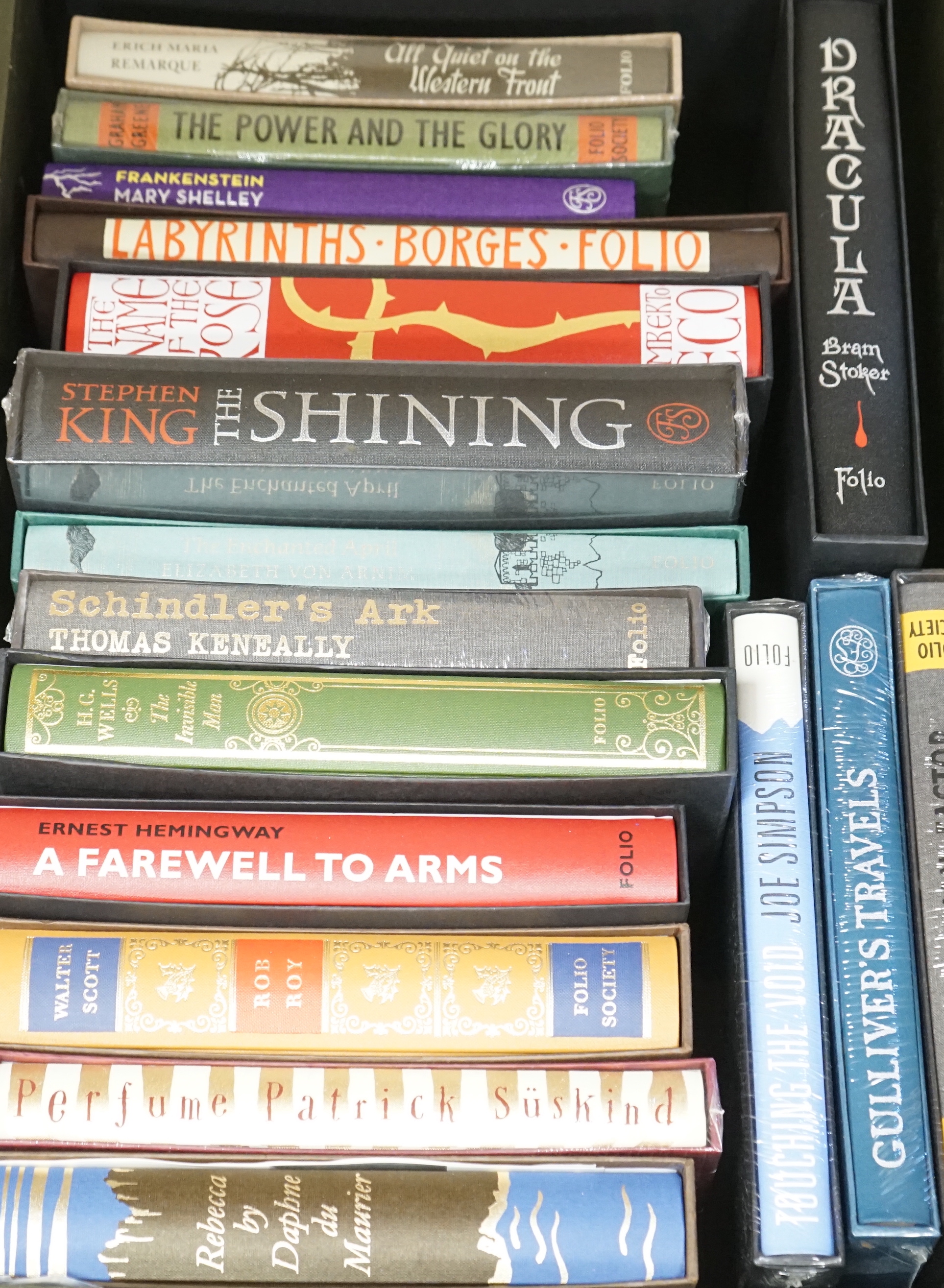 Eighteen Folio Society books, all fiction, including du Maurier, Daphne; Rob Roy; A Farewell to Arms; Wells’ The Invisible Man; Schindler’s Ark, etc.